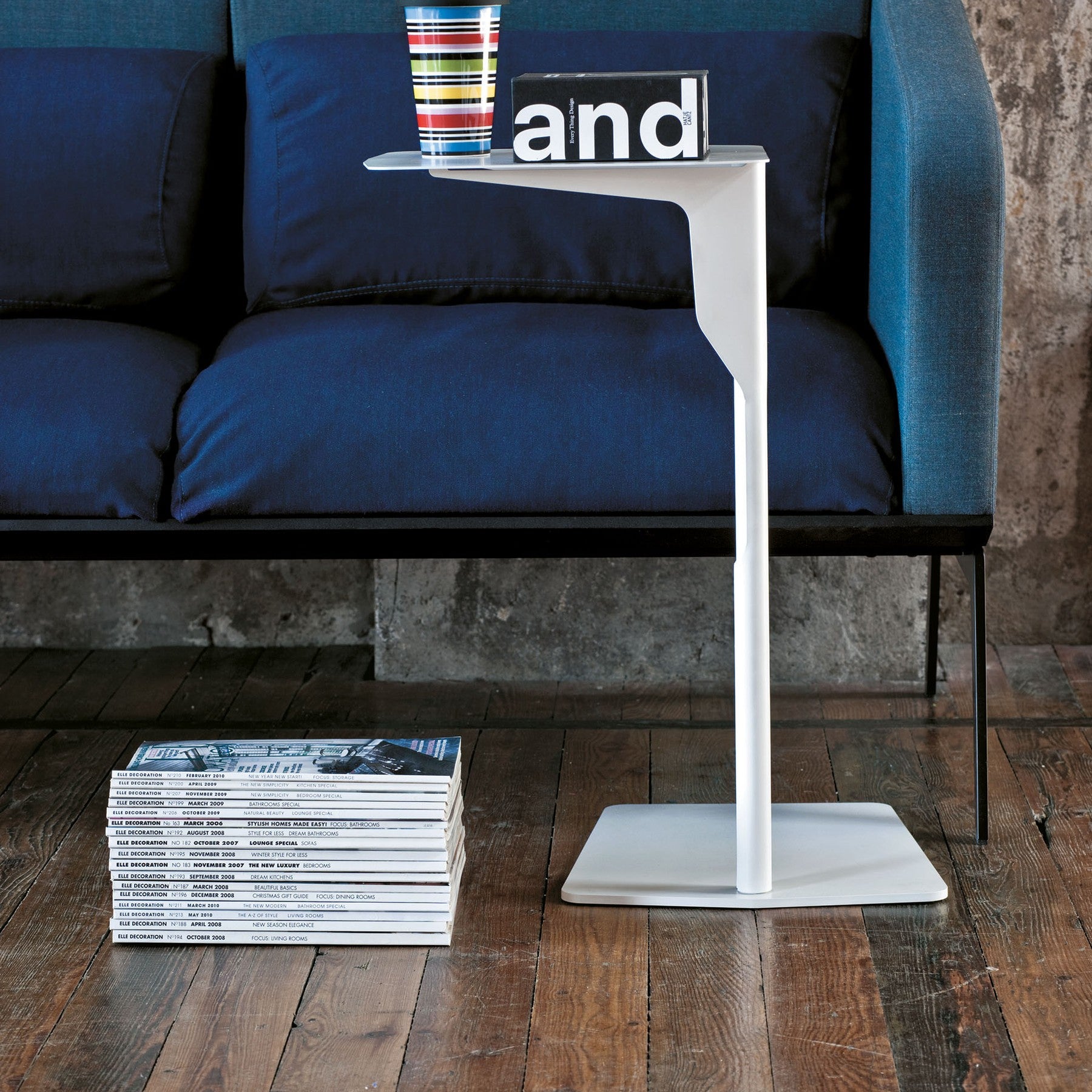 Tavolino ELLE Metal Table Frezza bianco accanto a un divano blu